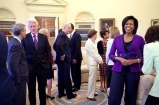 President Barack Obama, background, and First Lady Michelle Obama greet guests in the Oval Office April 21, 2009, including former President Bill Clinton, U.S. Senator Edward M. Kennedy, former first lady Rosalynn Carter, center, along with Vice President Joe Biden.